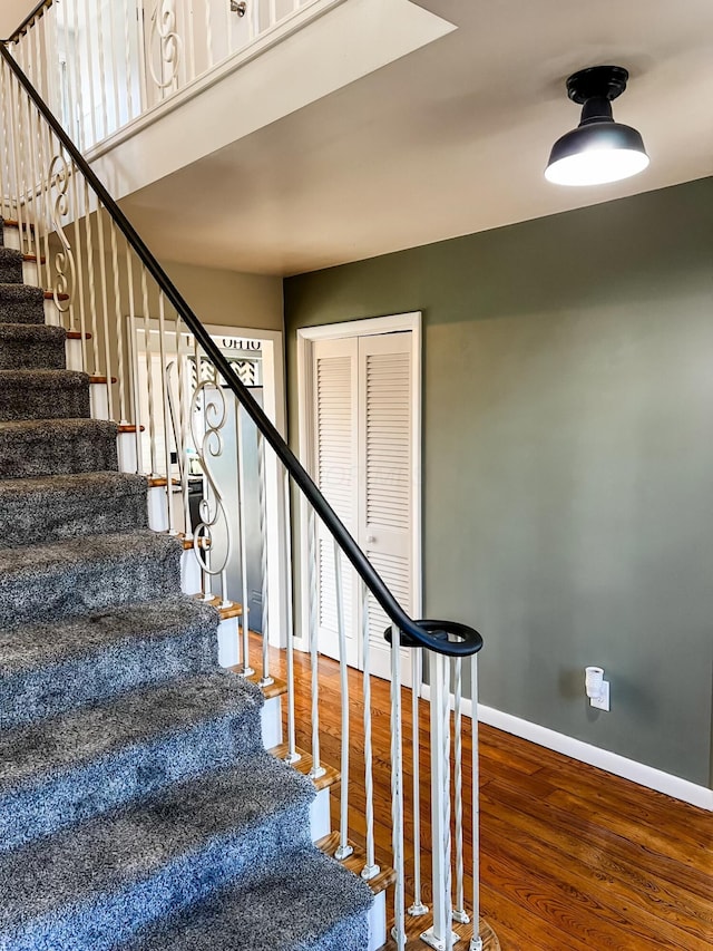 stairs with hardwood / wood-style flooring