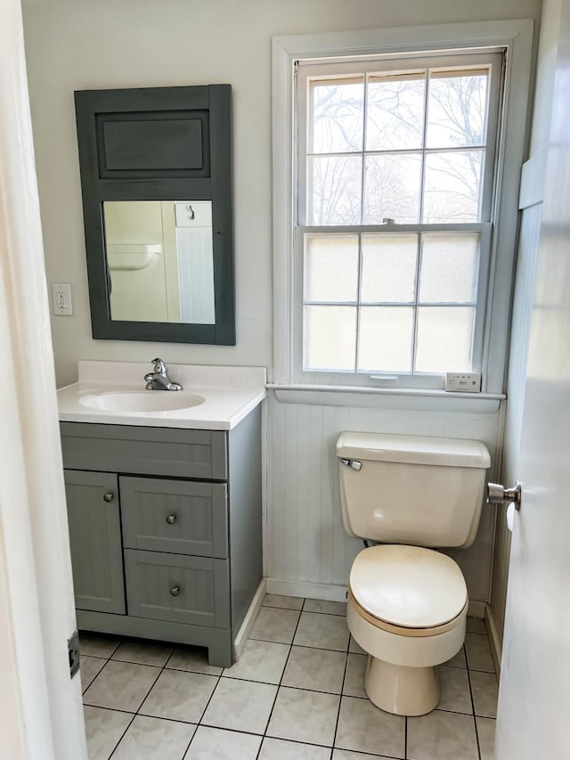 bathroom featuring tile patterned flooring, vanity, and toilet