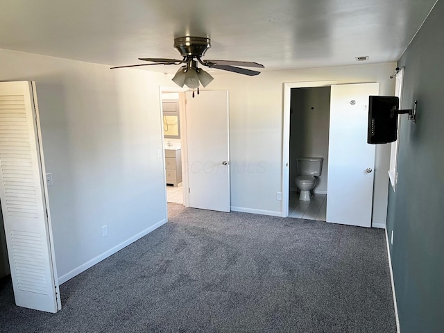 interior space featuring carpet, ceiling fan, and ensuite bath