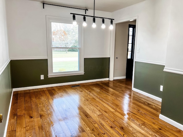 unfurnished dining area with hardwood / wood-style floors