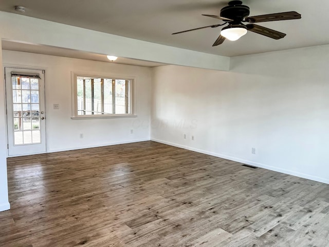 empty room with ceiling fan and hardwood / wood-style floors