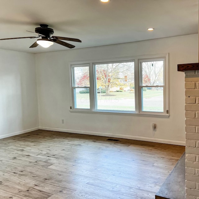 spare room featuring plenty of natural light and light hardwood / wood-style floors