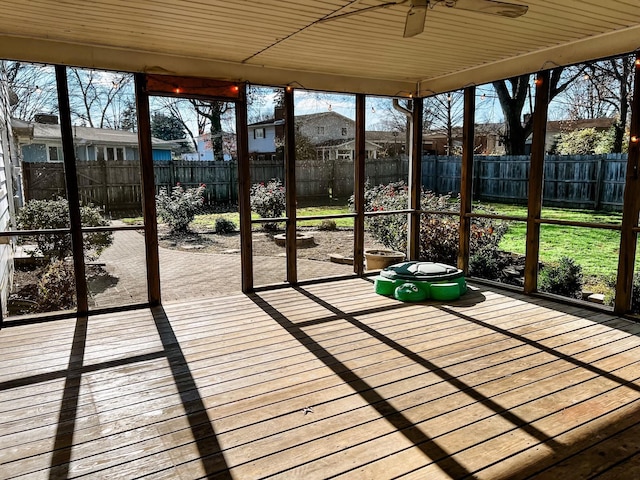 unfurnished sunroom with ceiling fan and wooden ceiling