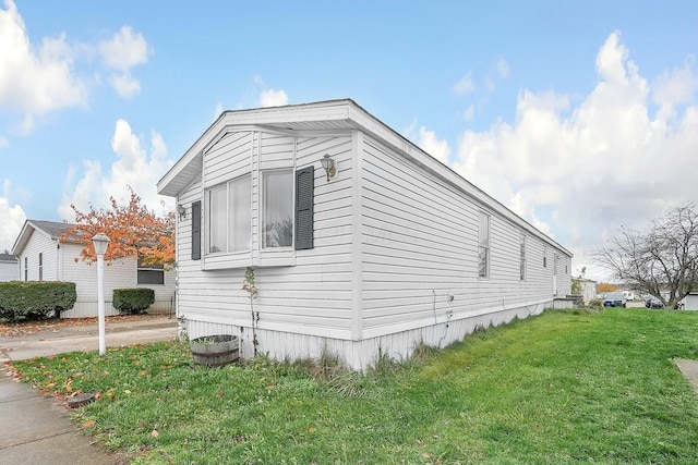 view of side of home with a lawn