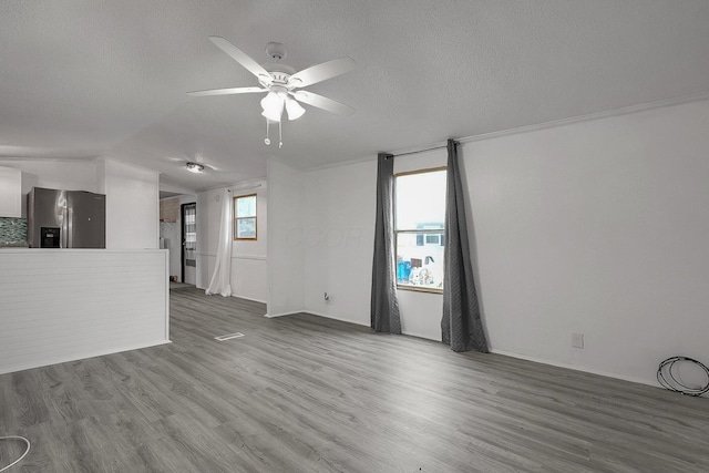 unfurnished living room featuring a textured ceiling, ceiling fan, and dark hardwood / wood-style floors