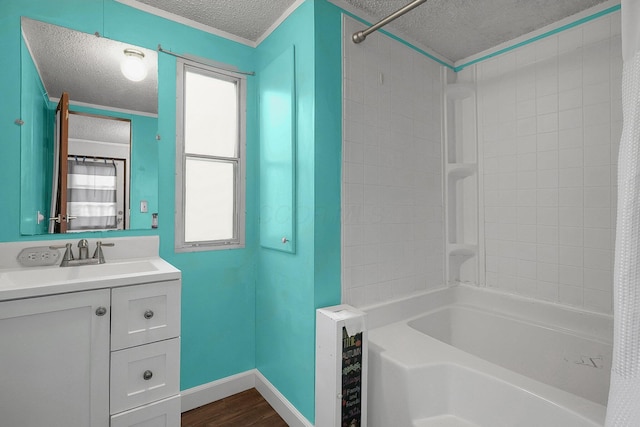 bathroom with crown molding, a textured ceiling, shower / tub combo with curtain, vanity, and hardwood / wood-style flooring