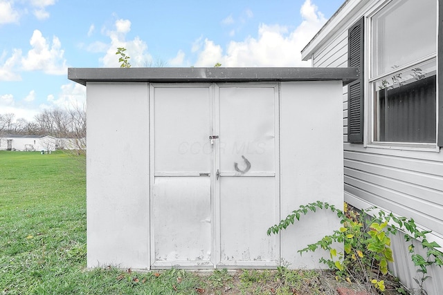 view of outbuilding with a yard