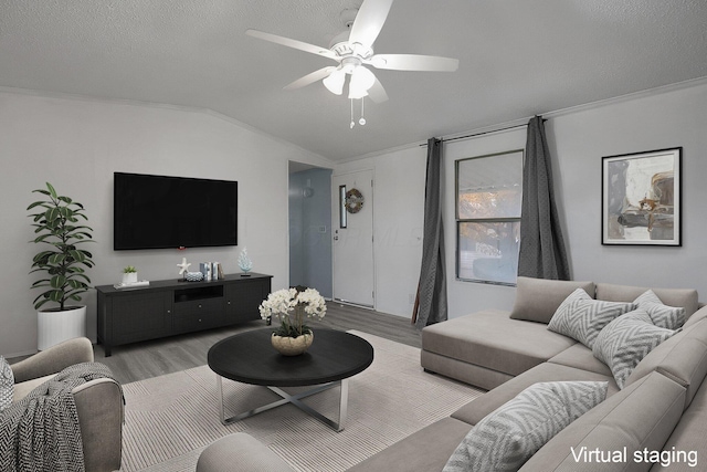 living room featuring a textured ceiling, ceiling fan, light hardwood / wood-style floors, and vaulted ceiling