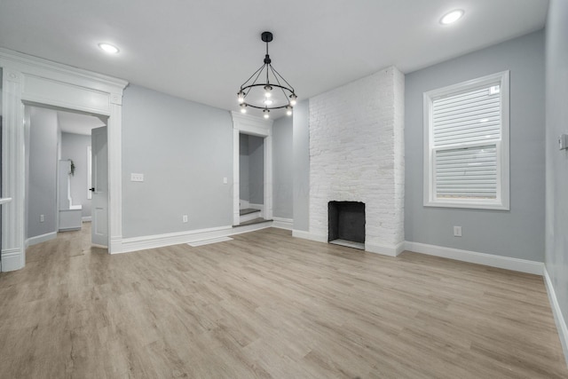 unfurnished living room featuring a fireplace and light wood-type flooring