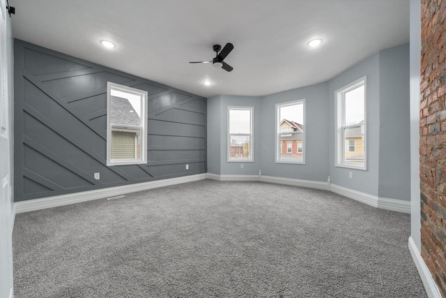 carpeted empty room featuring ceiling fan