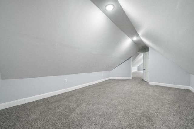 bonus room with carpet flooring and lofted ceiling