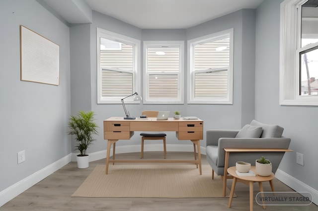 office space with light wood-type flooring and a wealth of natural light