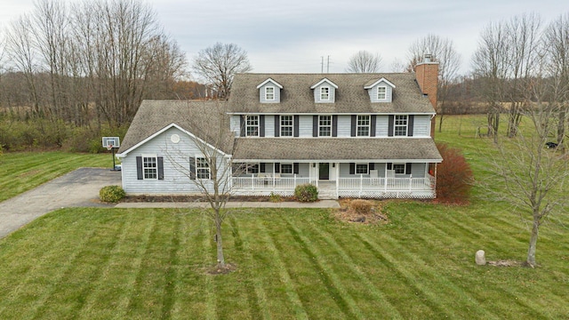 colonial home with a porch and a front yard