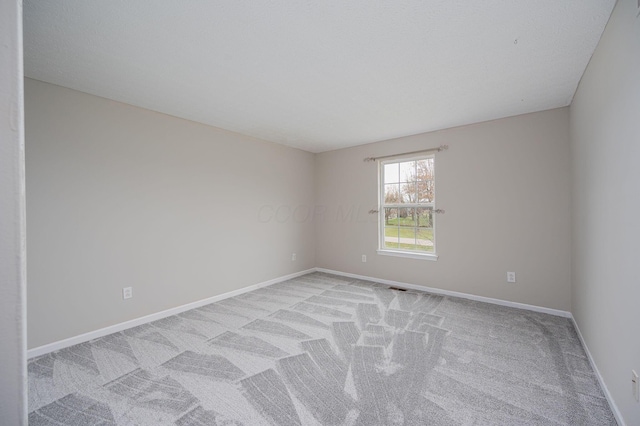 empty room featuring light carpet