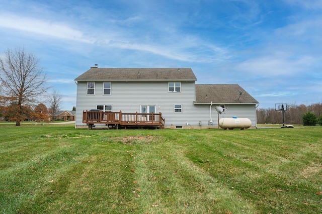 back of property with a yard and a wooden deck