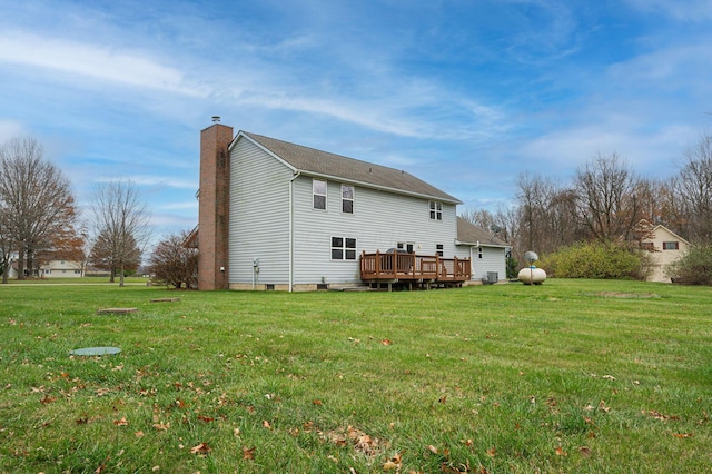 back of house with a deck and a yard