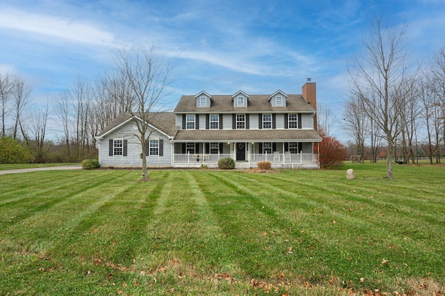 colonial inspired home with covered porch and a front yard