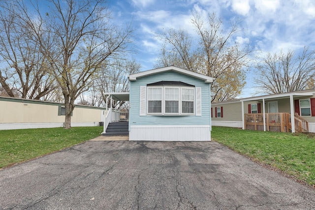 119 Skyline Dr, South Bloomfield, OH 43103 - manufactured / mobile home with covered porch, a front lawn, and driveway