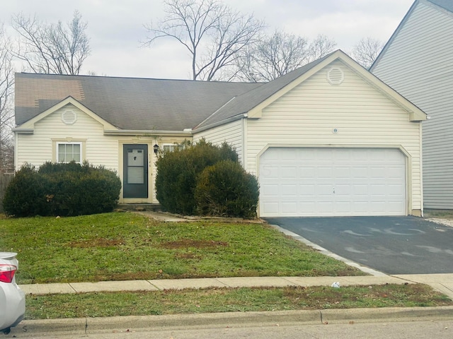 ranch-style house featuring a front yard and a garage