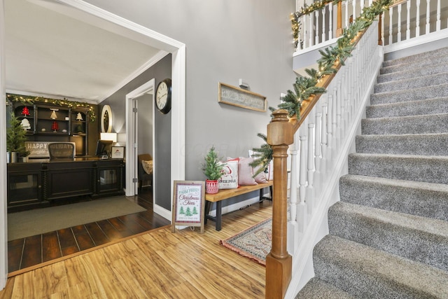 interior space featuring crown molding and hardwood / wood-style floors