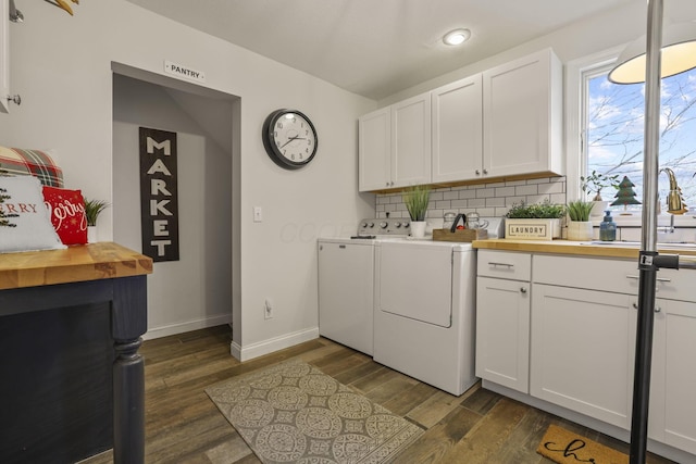 washroom featuring cabinets, separate washer and dryer, dark hardwood / wood-style flooring, and sink