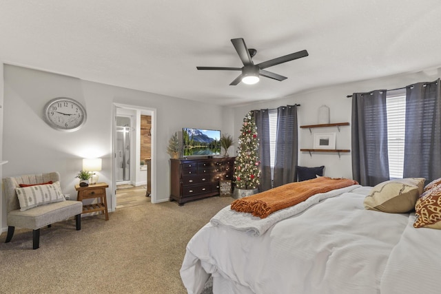 carpeted bedroom with ceiling fan and ensuite bathroom