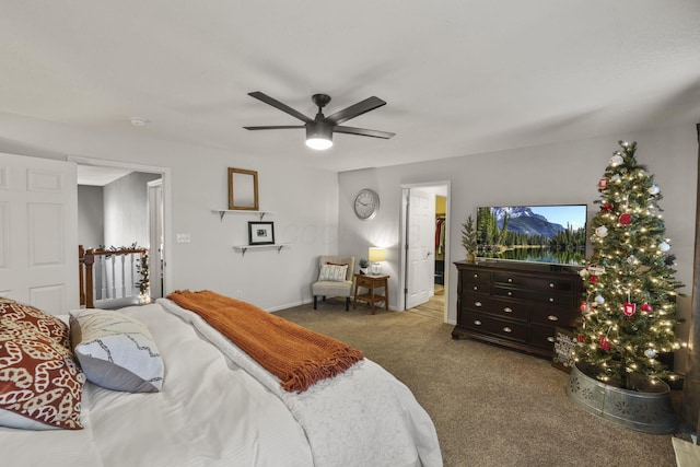 bedroom with ceiling fan, carpet floors, and ensuite bath