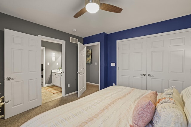 bedroom with ceiling fan, a closet, connected bathroom, and dark colored carpet