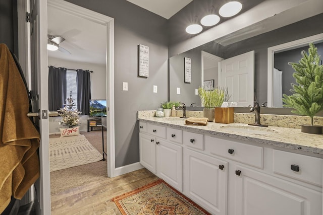 bathroom featuring ceiling fan, hardwood / wood-style flooring, and vanity