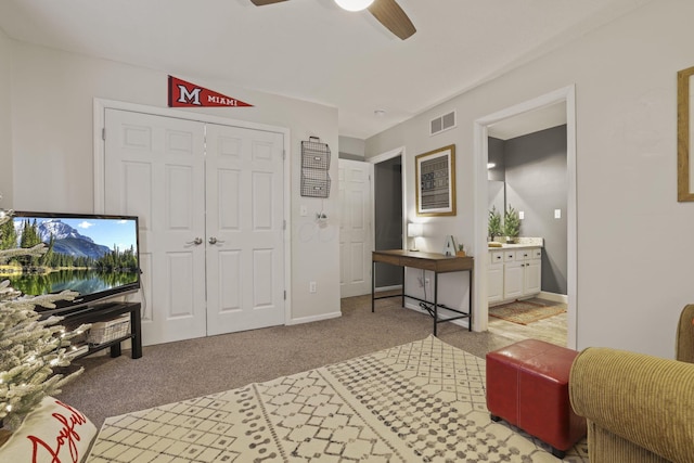 carpeted living room featuring ceiling fan