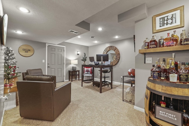 carpeted living room with bar area and a textured ceiling