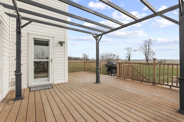 wooden terrace with grilling area, a pergola, and a yard