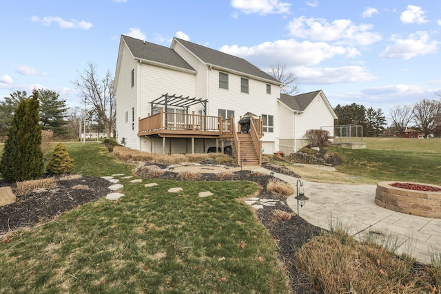 back of house featuring a wooden deck, a yard, a fire pit, and a pergola