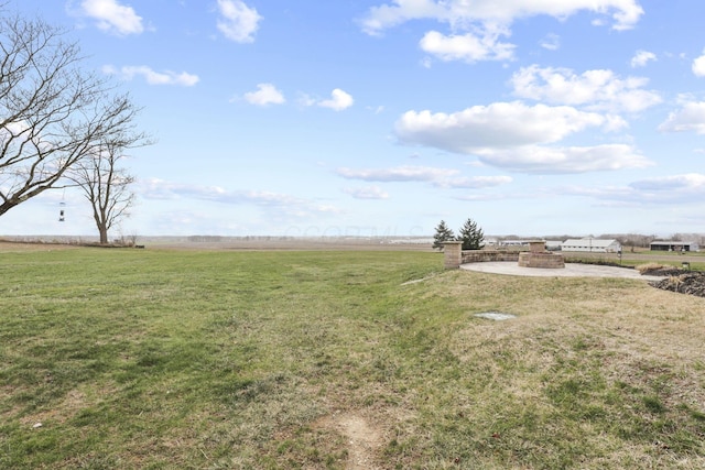 view of yard with a rural view