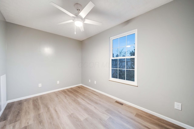 unfurnished room with ceiling fan, light hardwood / wood-style floors, and a textured ceiling