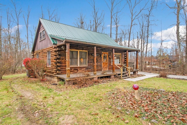 log-style house featuring a porch and a front yard