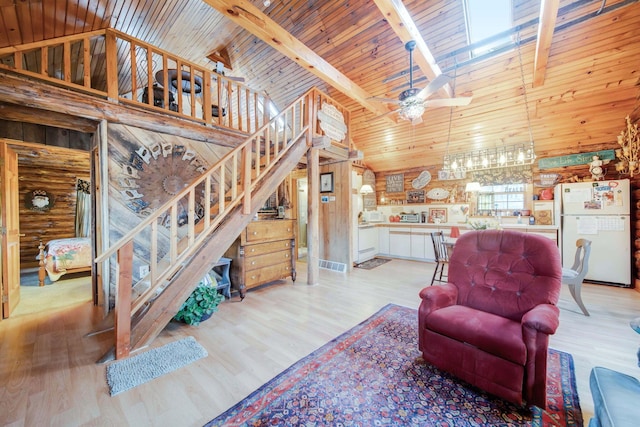 living room with ceiling fan, light hardwood / wood-style flooring, beamed ceiling, high vaulted ceiling, and wooden walls