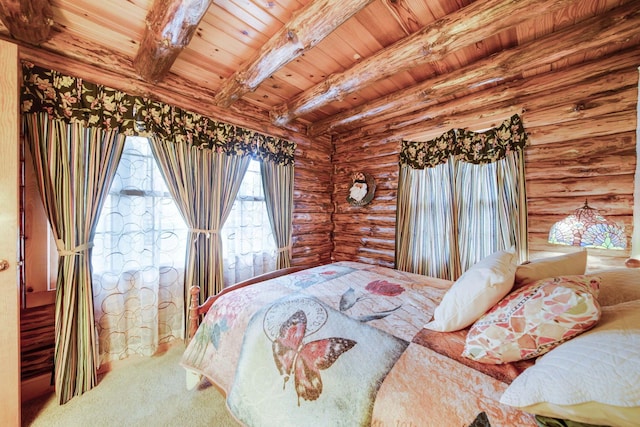 bedroom featuring beam ceiling, log walls, and wooden ceiling