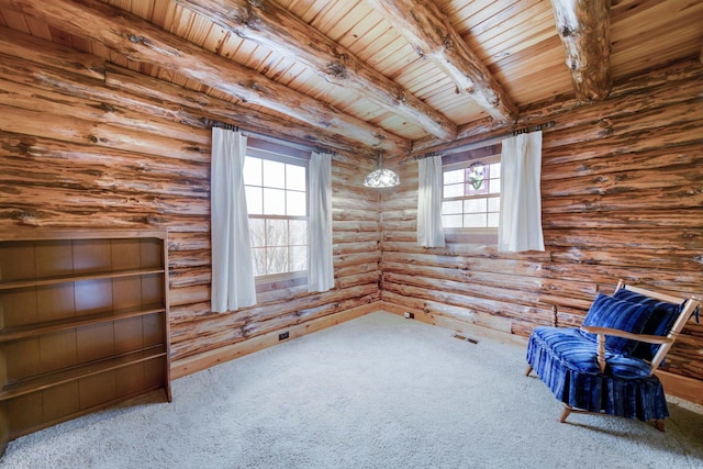 unfurnished room featuring beamed ceiling, rustic walls, a wealth of natural light, and wood ceiling