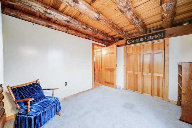 living area with carpet, wood ceiling, and beamed ceiling