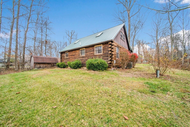 exterior space featuring central AC and a yard