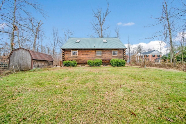 back of house with an outbuilding and a yard