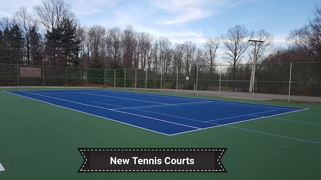 view of tennis court with basketball hoop