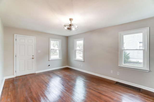 empty room with dark wood-type flooring