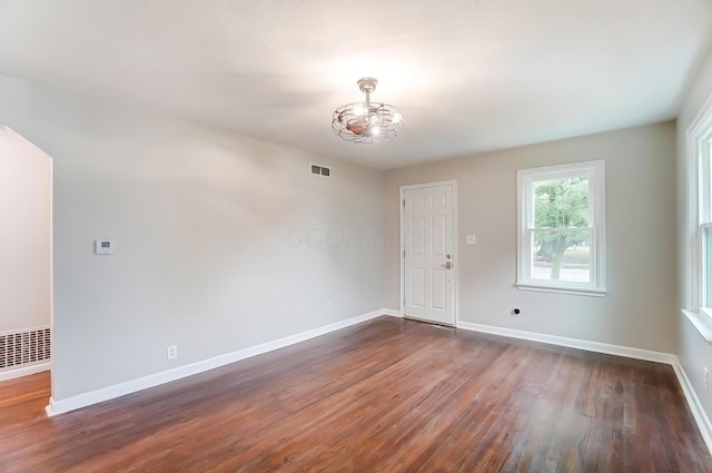 spare room with dark hardwood / wood-style floors