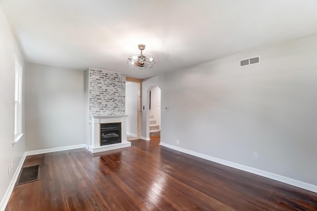 unfurnished living room featuring dark hardwood / wood-style flooring