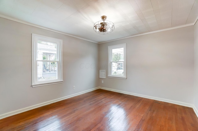 spare room with hardwood / wood-style floors and ornamental molding