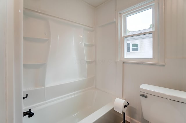 bathroom featuring bathtub / shower combination and toilet