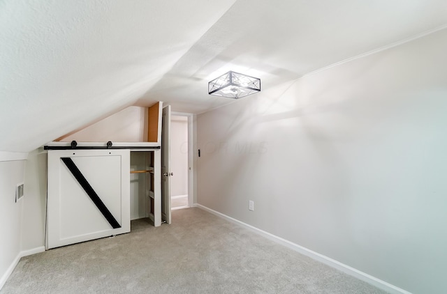 bonus room with lofted ceiling, carpet flooring, and a textured ceiling