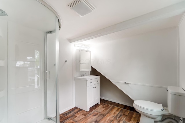 bathroom featuring hardwood / wood-style flooring, vanity, an enclosed shower, and toilet